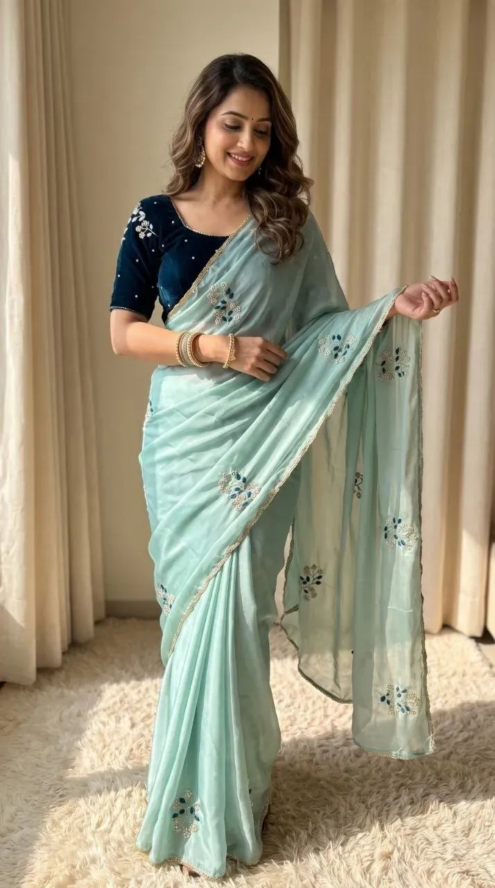 Model posing in mint green soft rangoli silk party wear saree