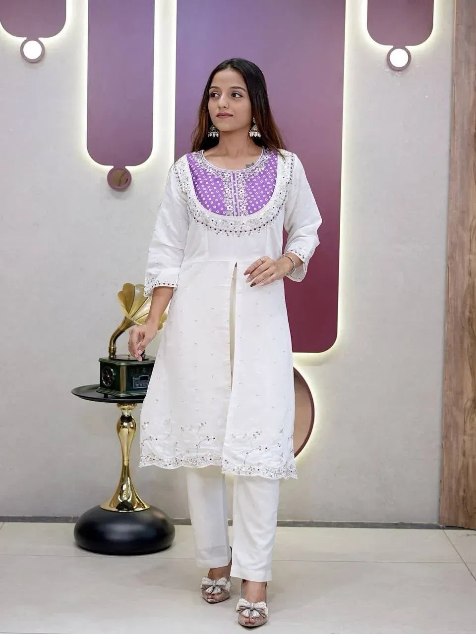 Front full-body view of model wearing white kurti set with purple yoke