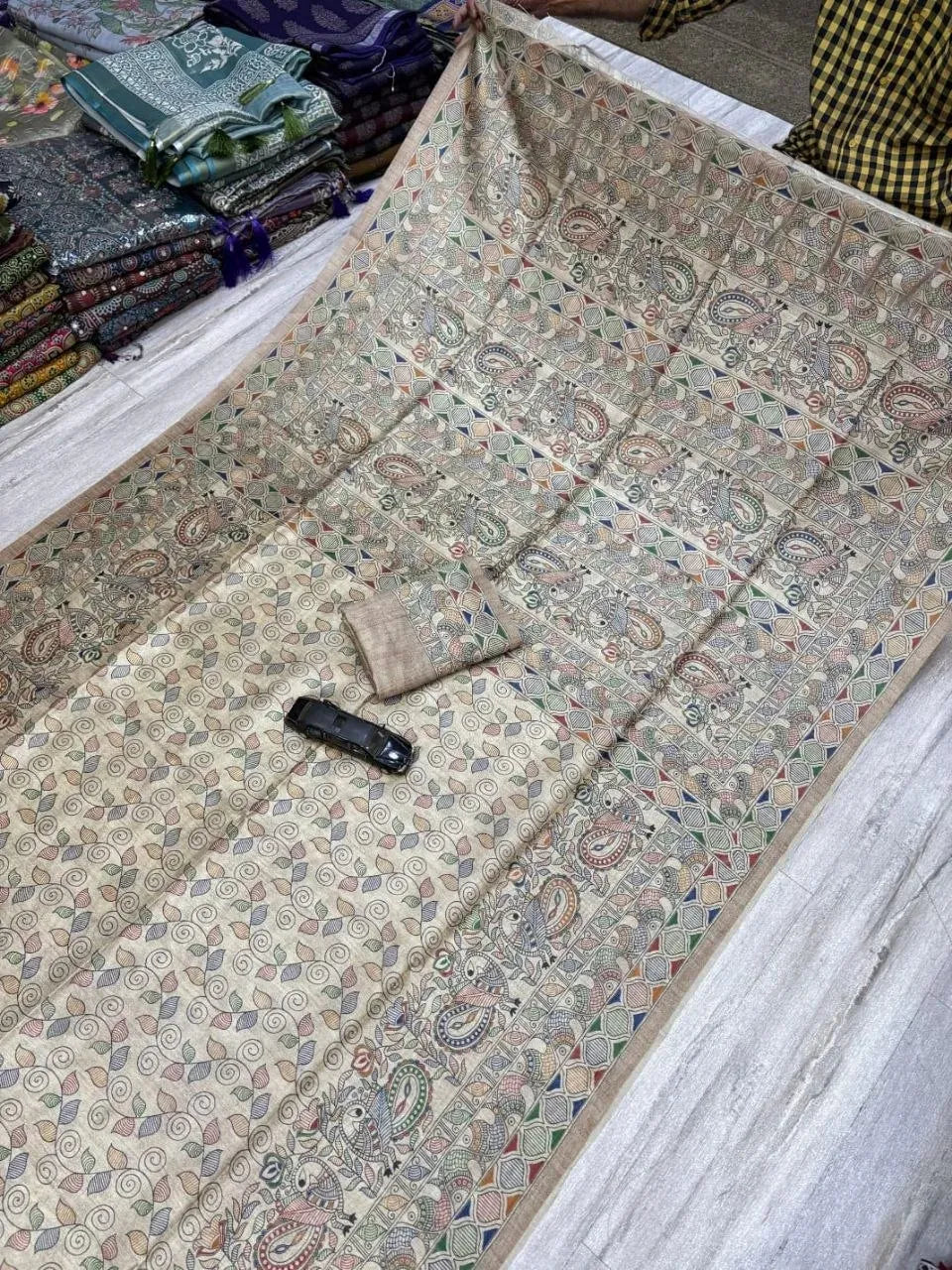 Full length view of silk blend Madhubani print saree displayed flat