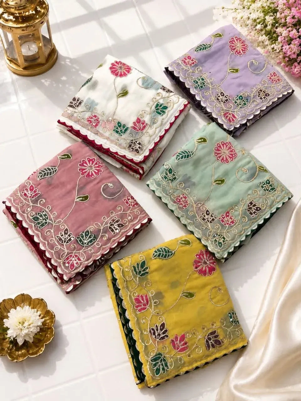 Assorted collection of soft casino crush sarees in white, lavender, pista, pink, and yellow