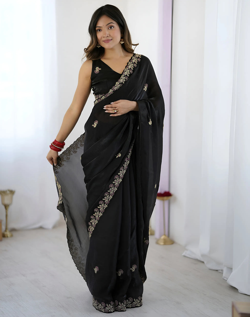 Front view of woman showcasing black soft saree with cutwork border