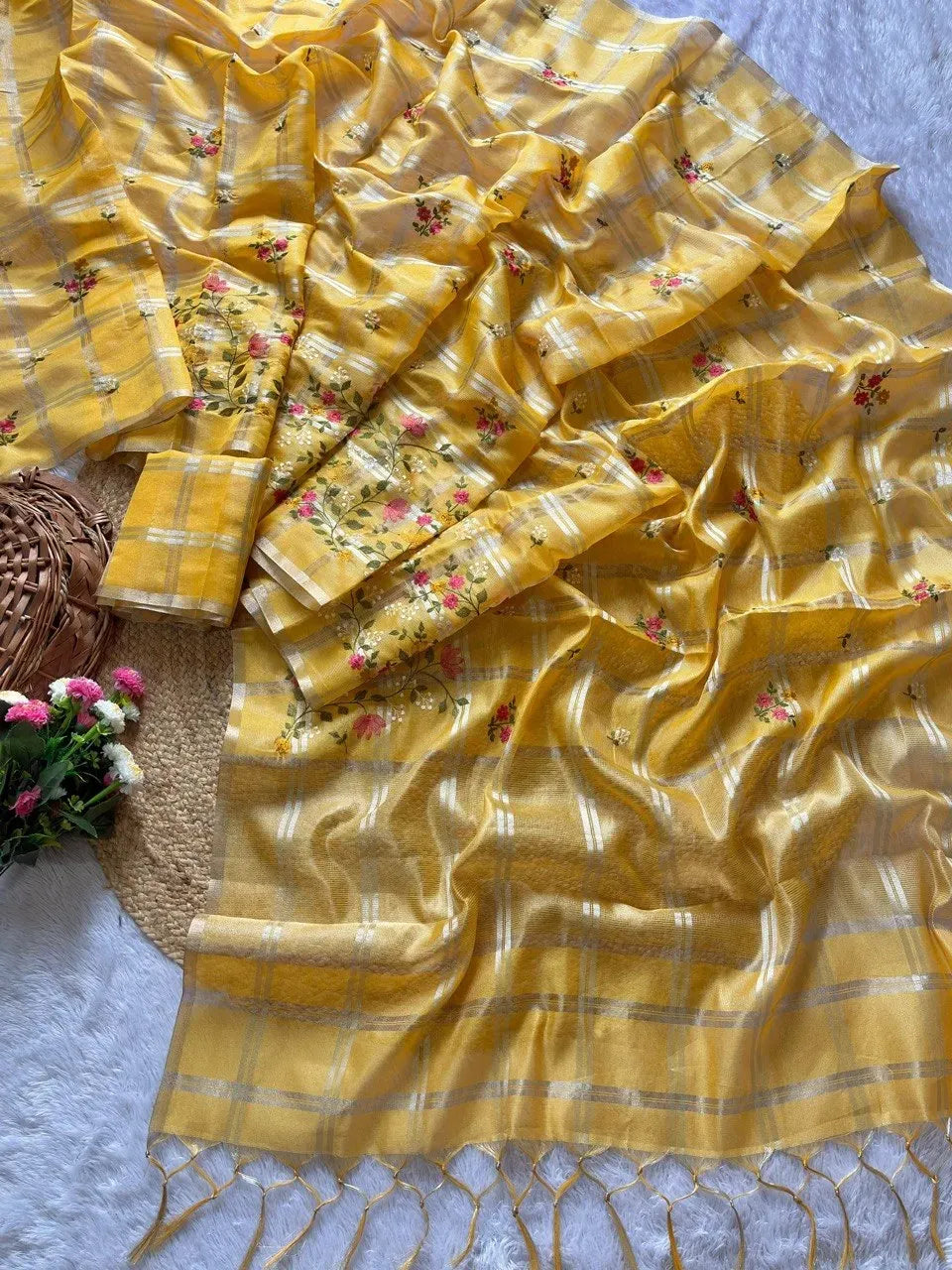 Yellow tusser chex saree draped with running blouse piece and tassels