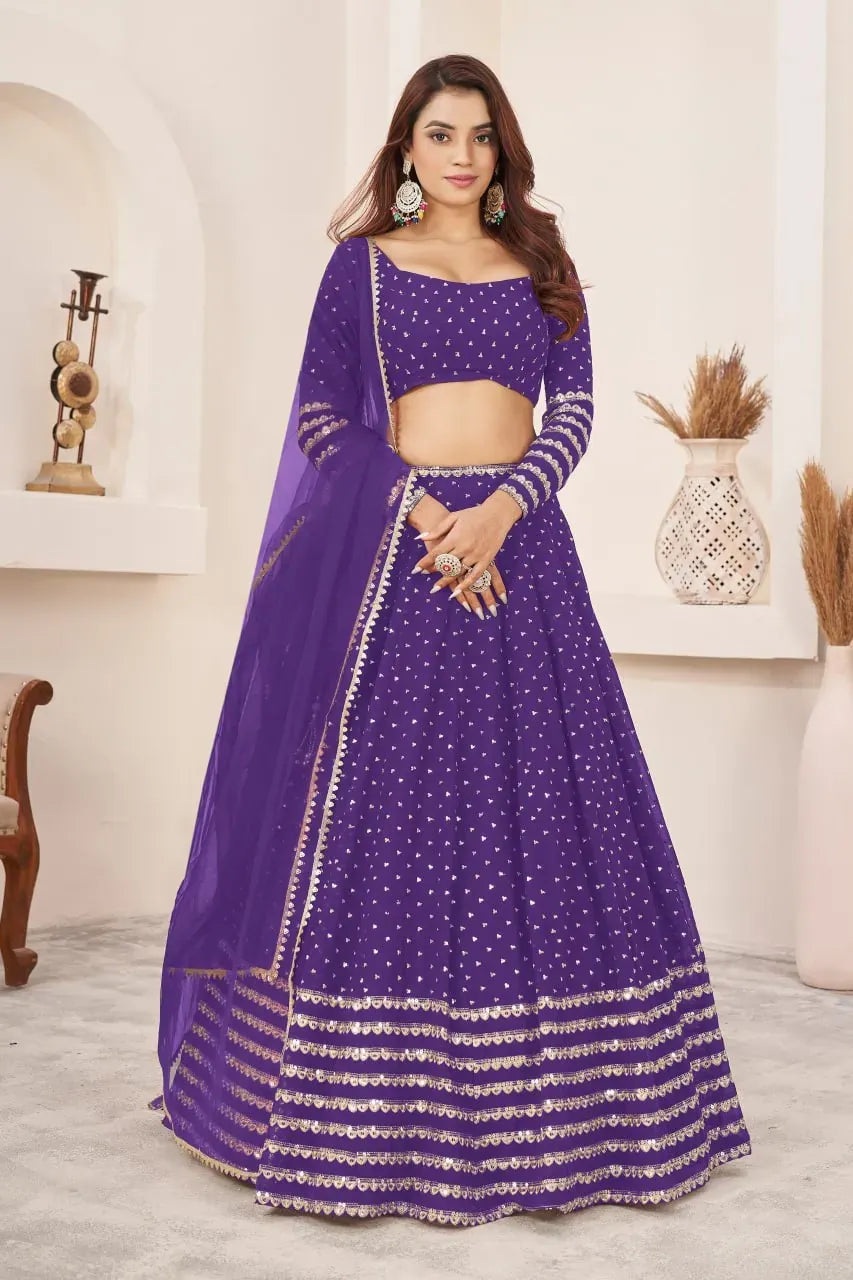 Model wearing violet georgette lehenga choli with heavy sequins work facing front