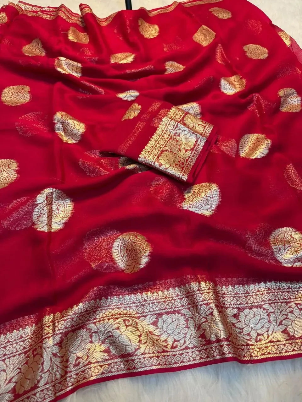 Red viscose georgette saree with gold zari motifs and border