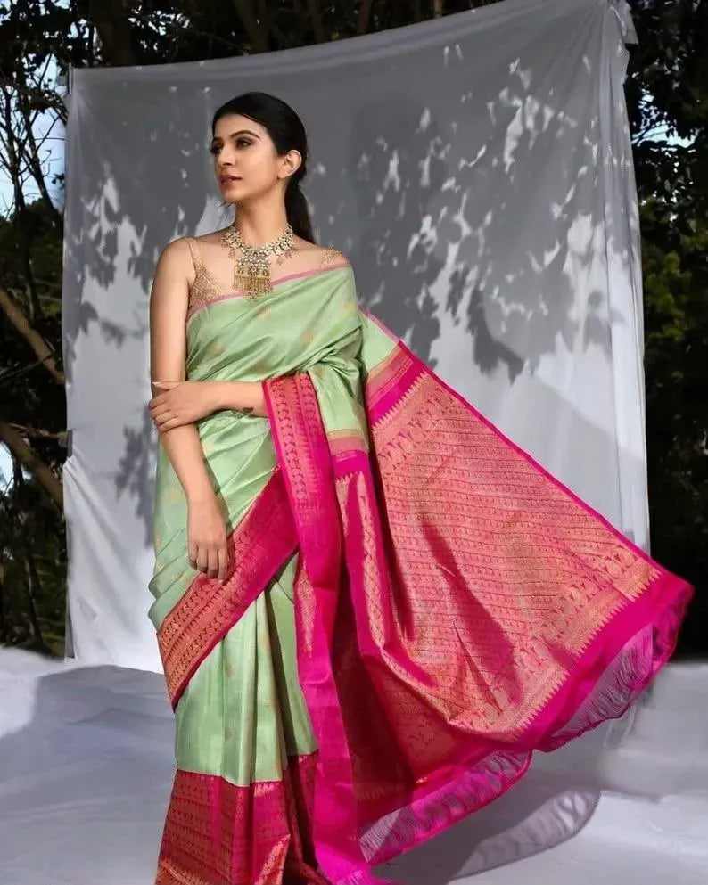 Model wearing green banarasi silk saree with rich pink zari pallu