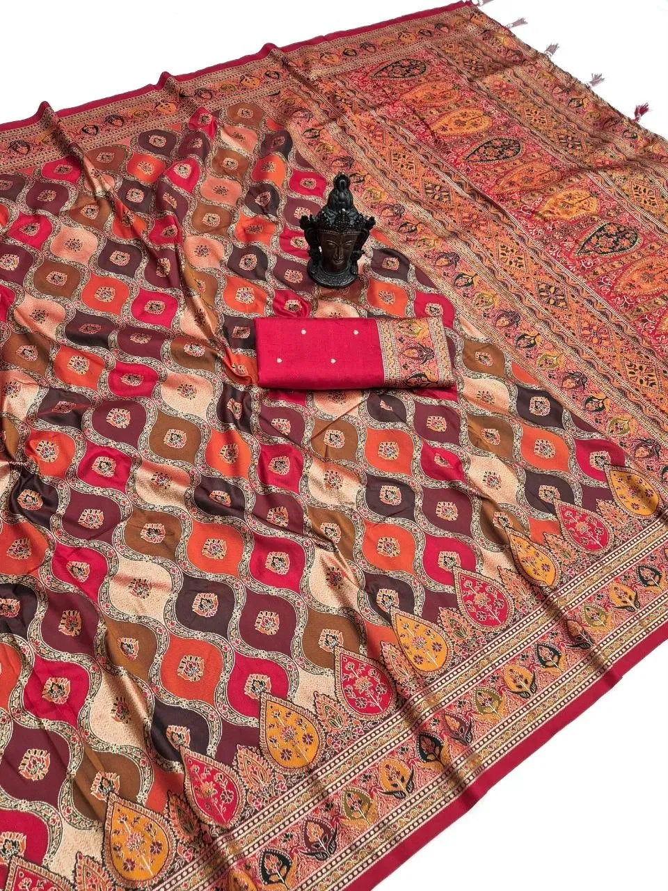 Red and brown patterned banarasi silk saree flat lay with matching blouse piece