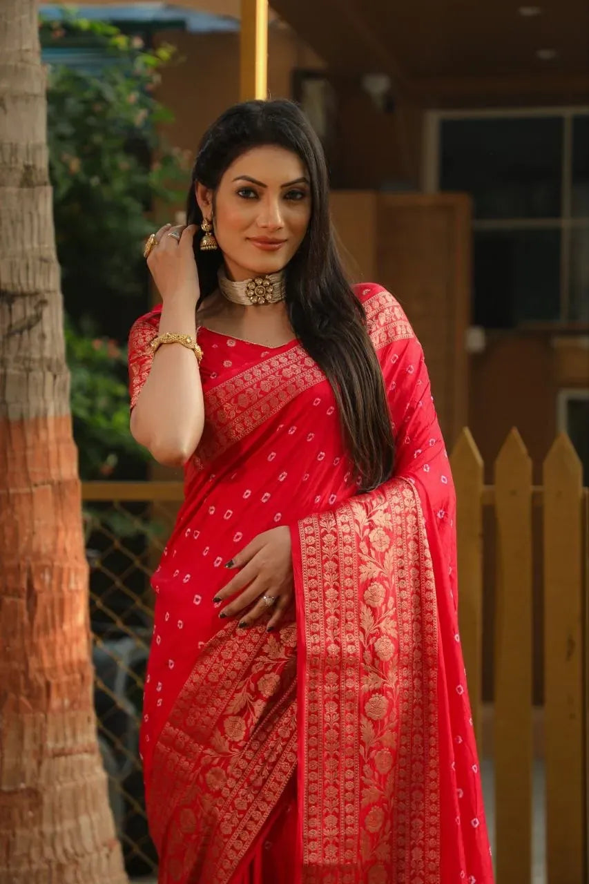 Model wearing bright red bandhej silk saree with gold zari border