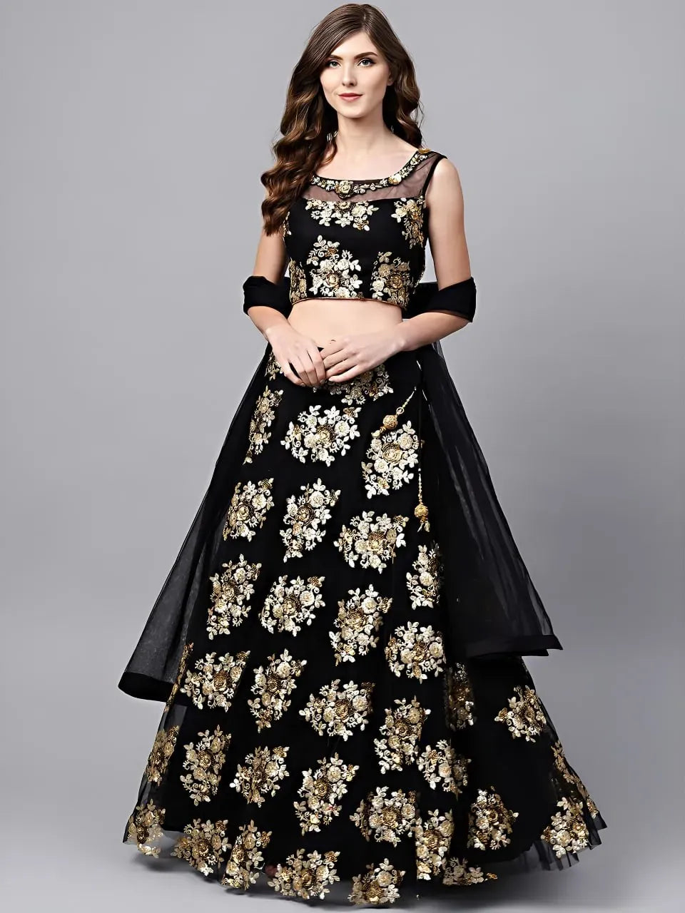Model wearing black net lehenga choli with gold and ivory floral sequins
