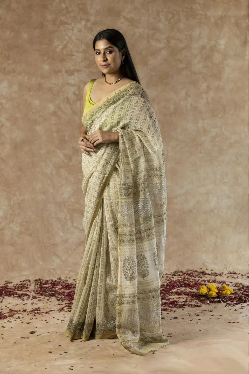 Model wearing beige printed chanderi saree with traditional motifs
