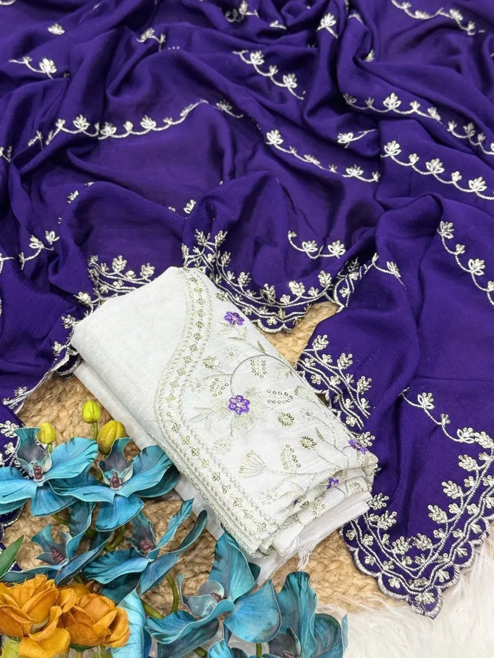 Purple chinnon chiffon saree with intricate silver embroidery and folded white blouse
