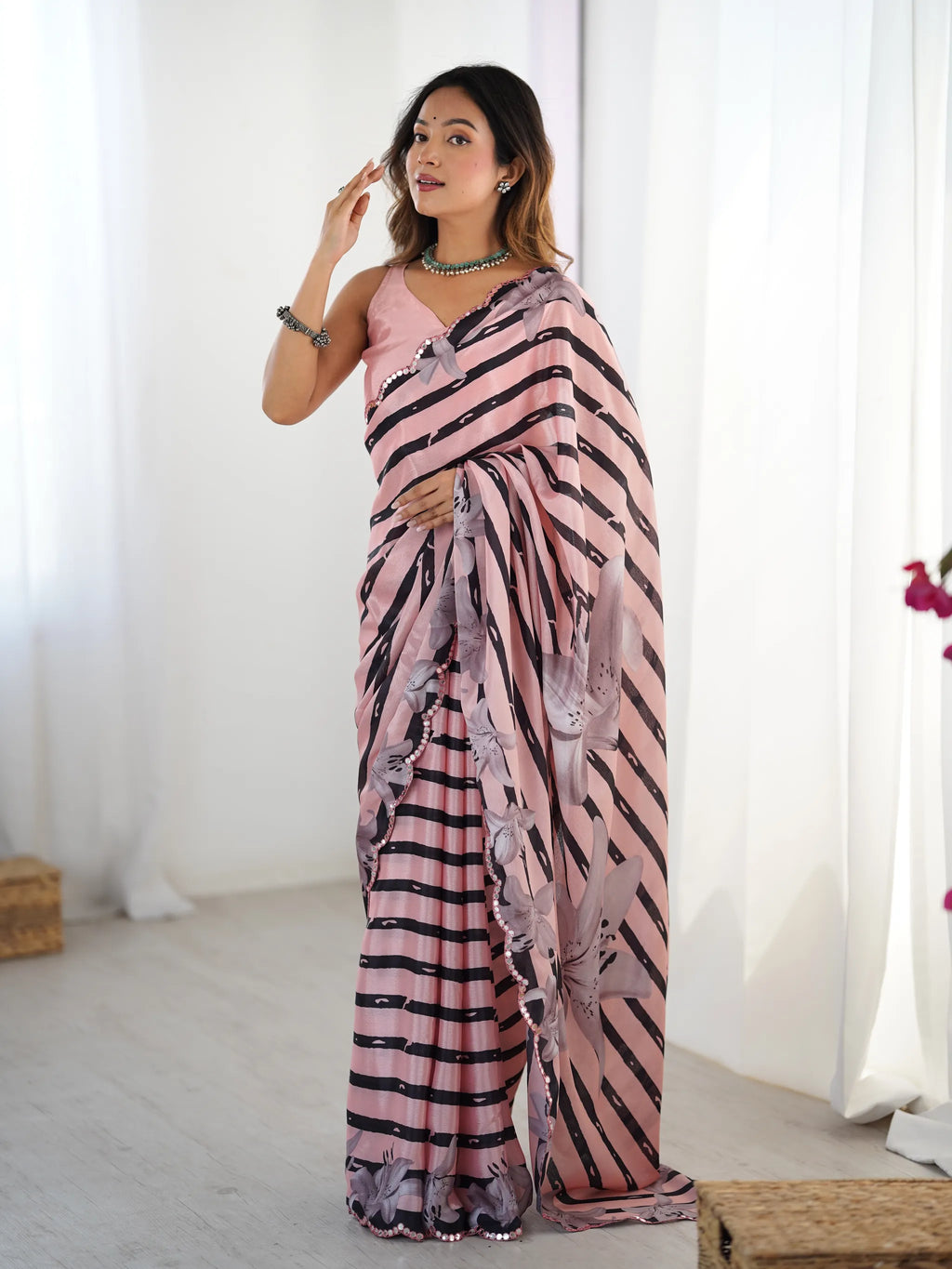 Full body front view of model in pink printed chinnon saree