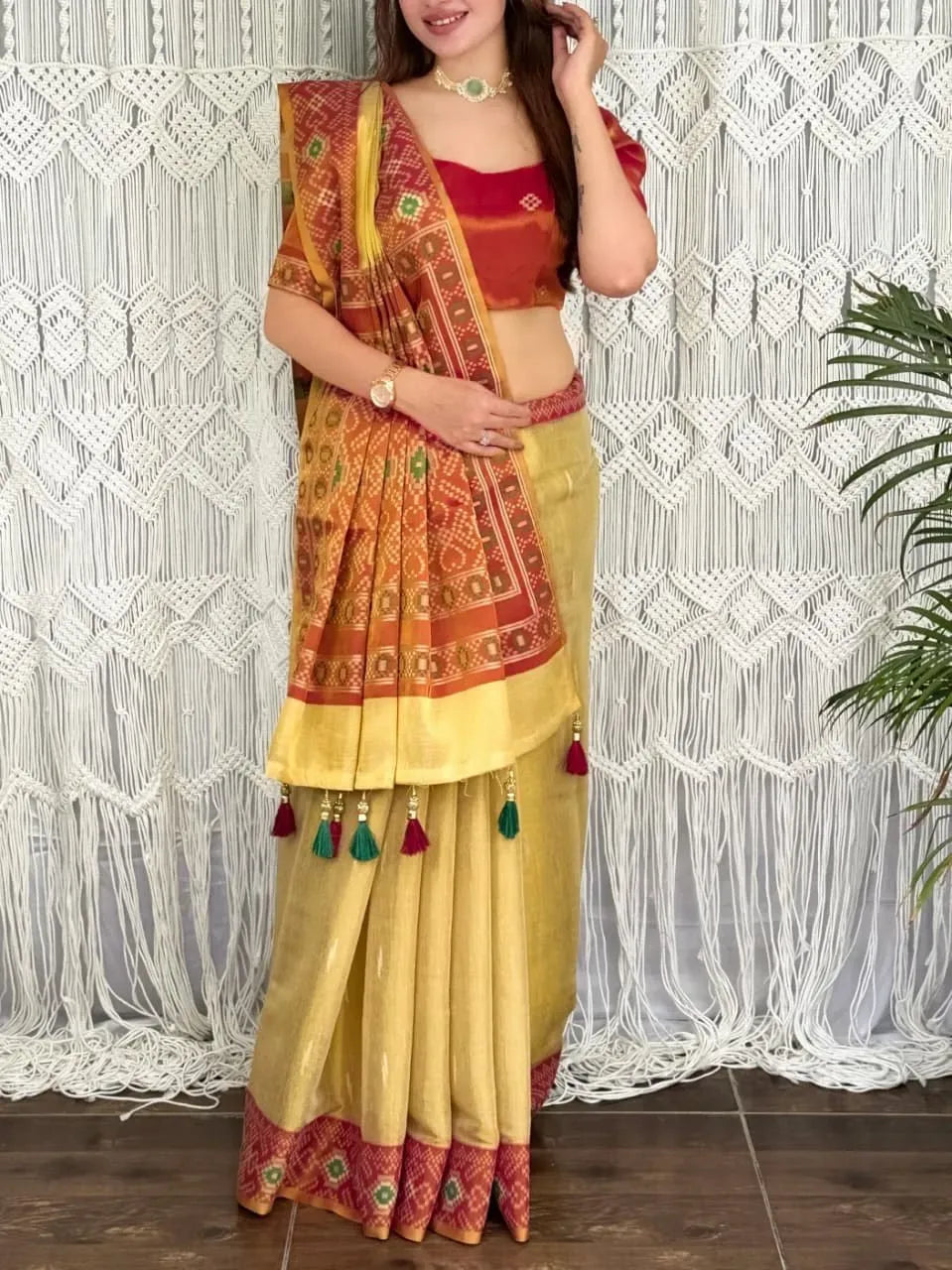 Woman wearing yellow cotton silk saree with red zari pallu