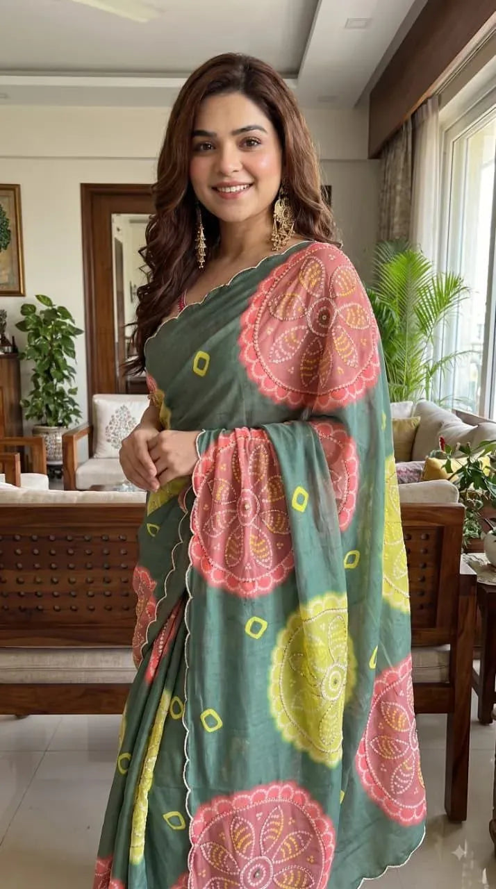 Model wearing green designer bandhani chiffon saree with heavy handwork border