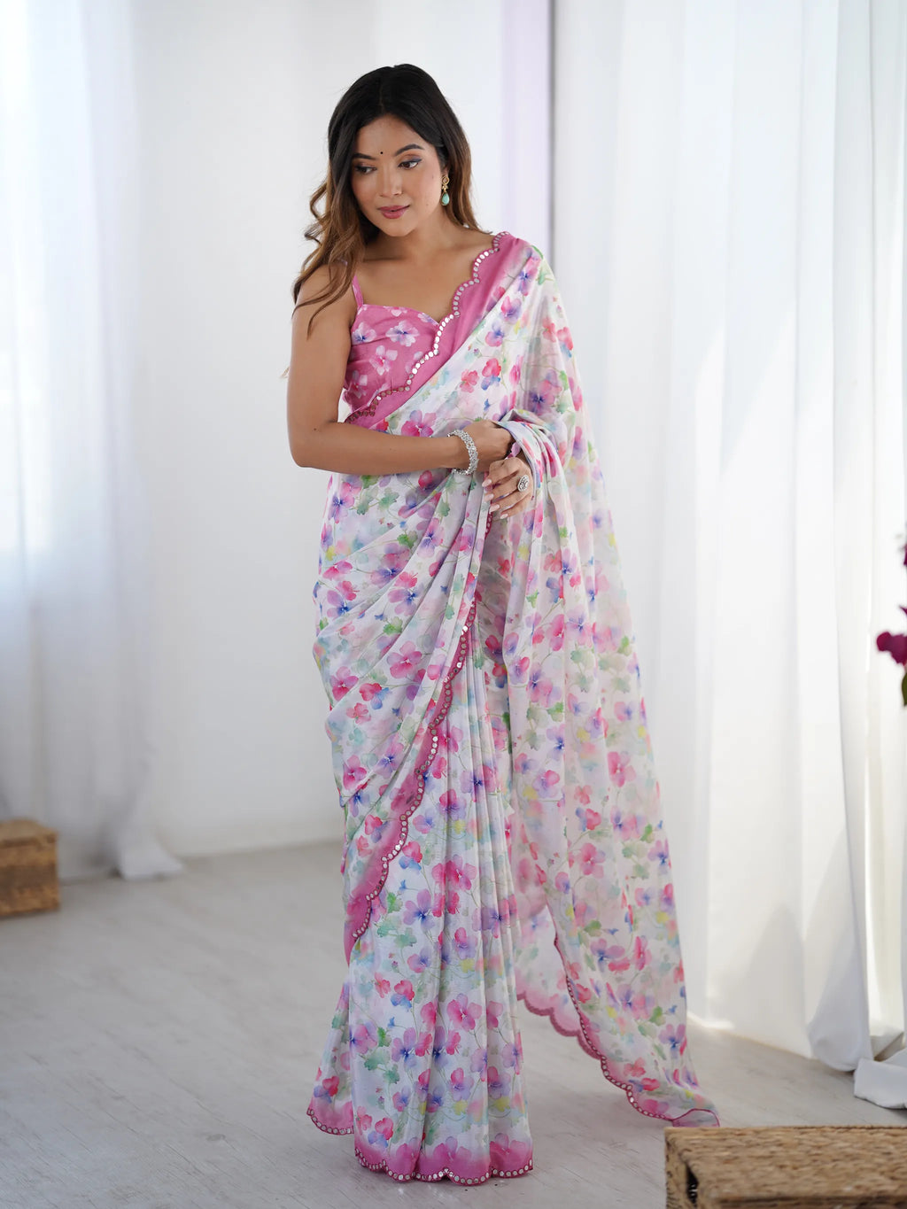 Full view of model in floral chinnon saree with matching pink blouse