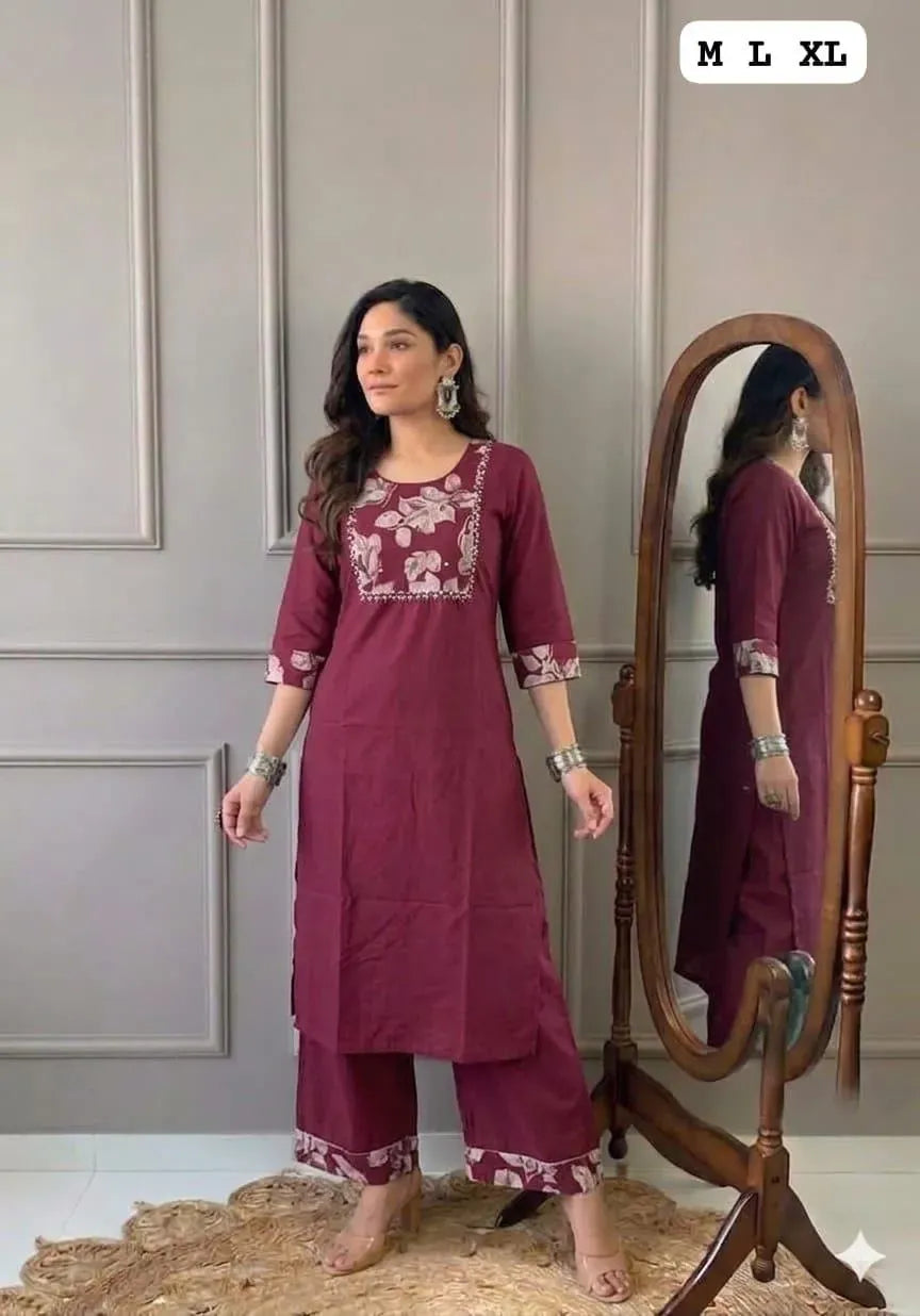 Model wearing maroon straight cotton kurti set with handwork and matching pants