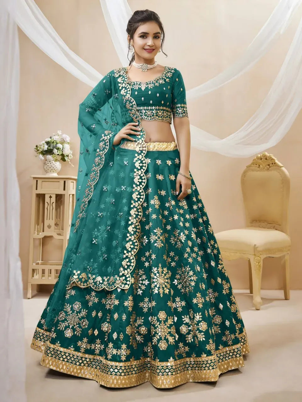 Model wearing emerald green lehenga choli with zari embroidery and dupatta