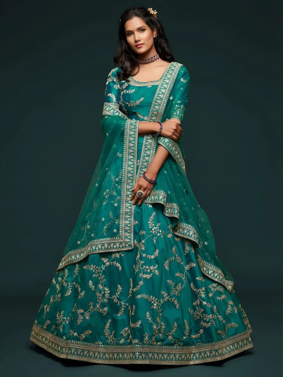 Model wearing teal green embroidered lehenga choli with dupatta front view