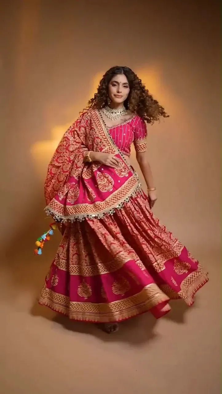 Model gracefully posing in pink festive lehenga choli with heavy flair