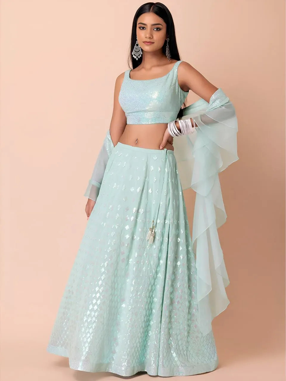 Model wearing icy aqua sequin lehenga with square neck blouse and ruffle dupatta