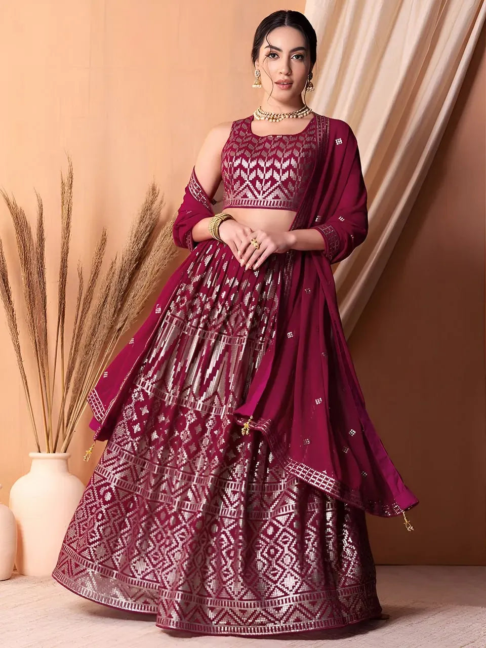 Model wearing ruby pink geometric sequin embroidered lehenga with matching dupatta
