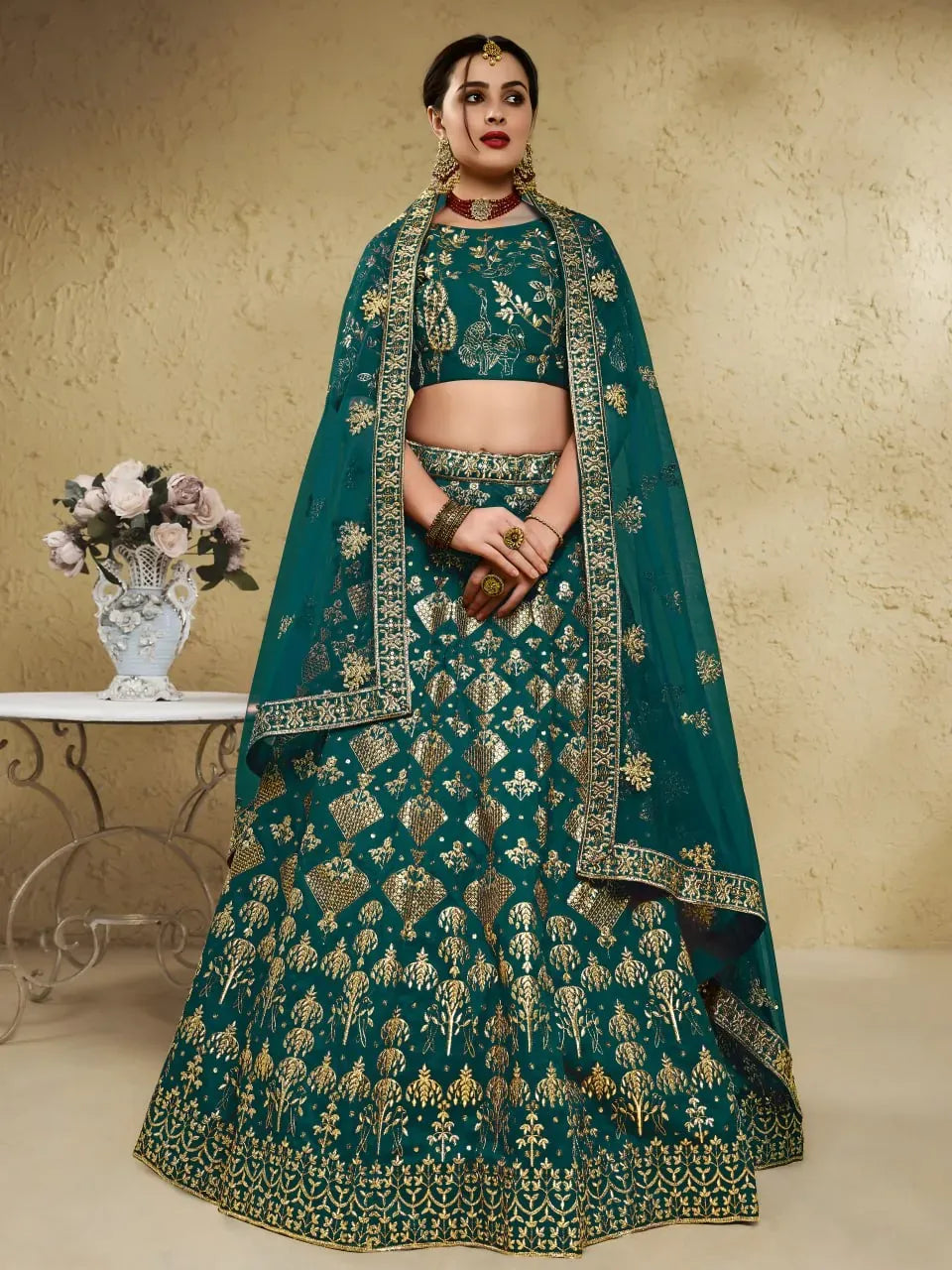 Model wearing deep emerald green embroidered lehenga choli with dupatta