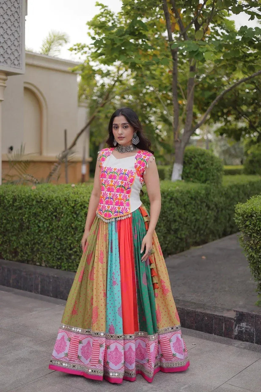 Model wearing multi-color printed cotton lehenga with mirror work border outdoors