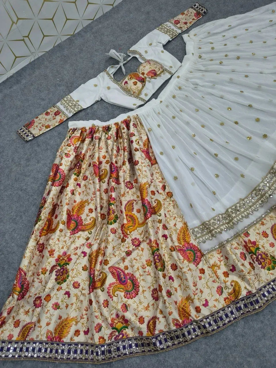 Model wearing traditional white and multicolored lehenga at heritage palace
