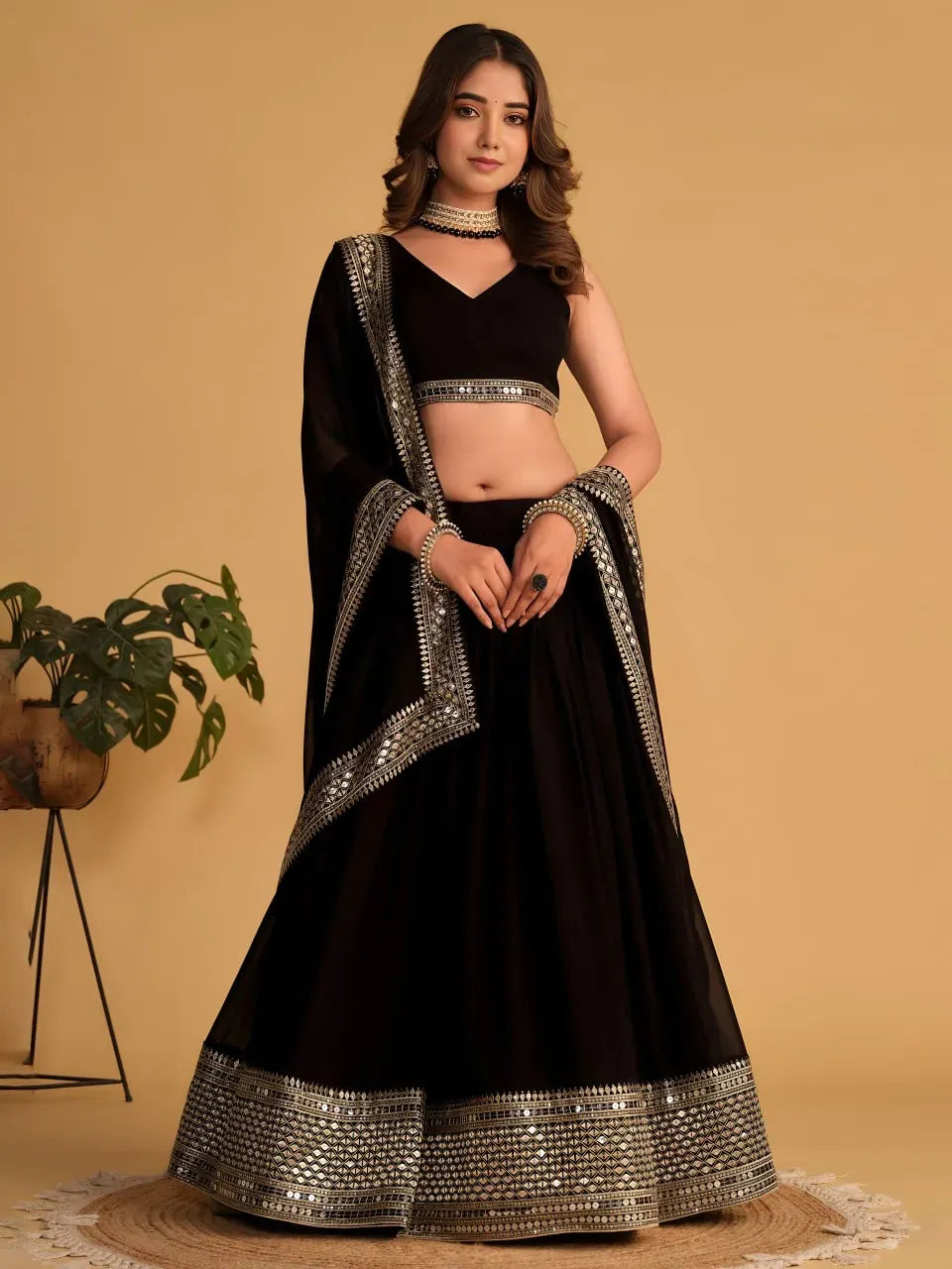 Model wearing black georgette lehenga with geometric sequins work hem