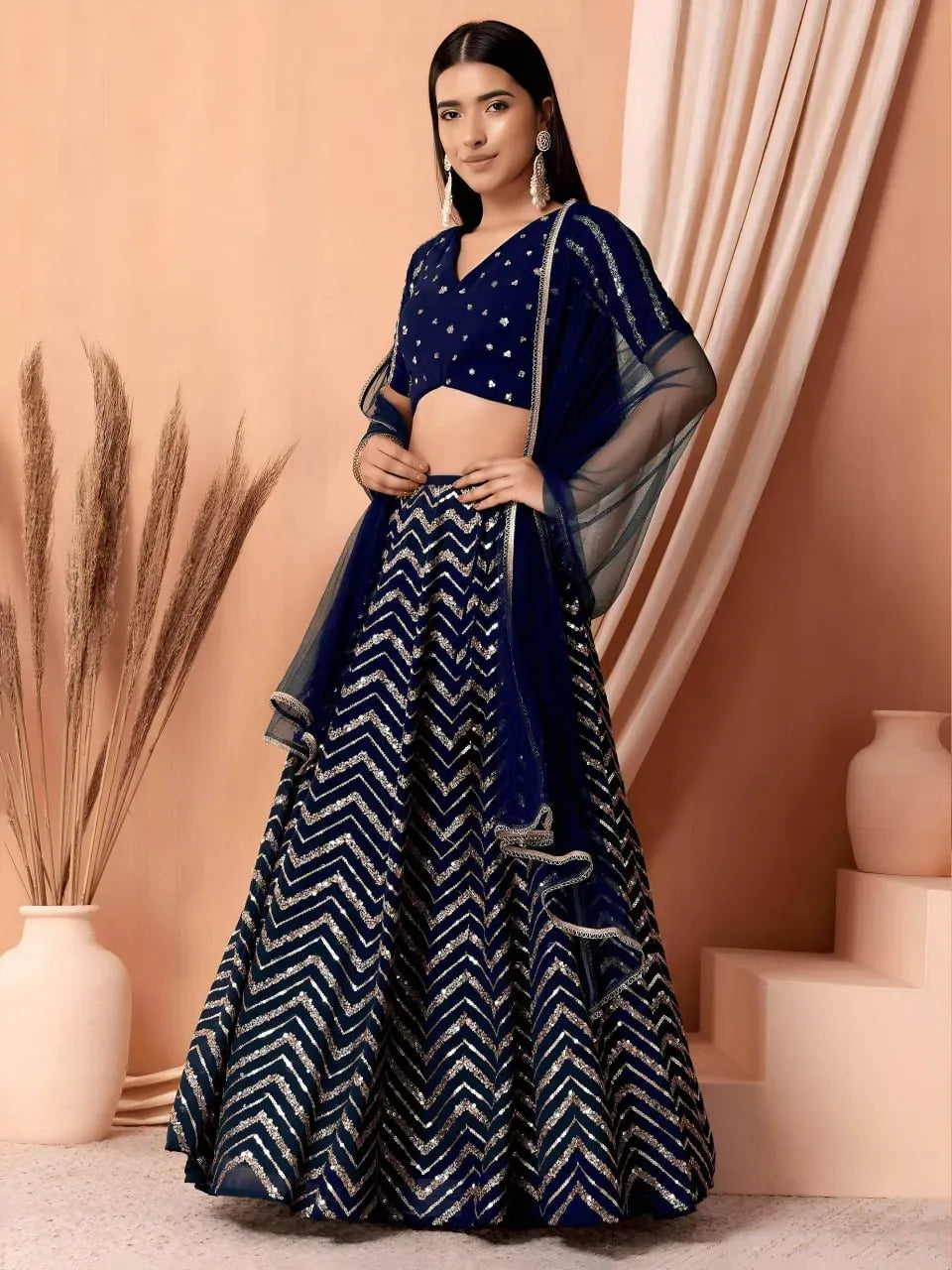 Model wearing royal navy chevron sparkle lehenga with sheer dupatta