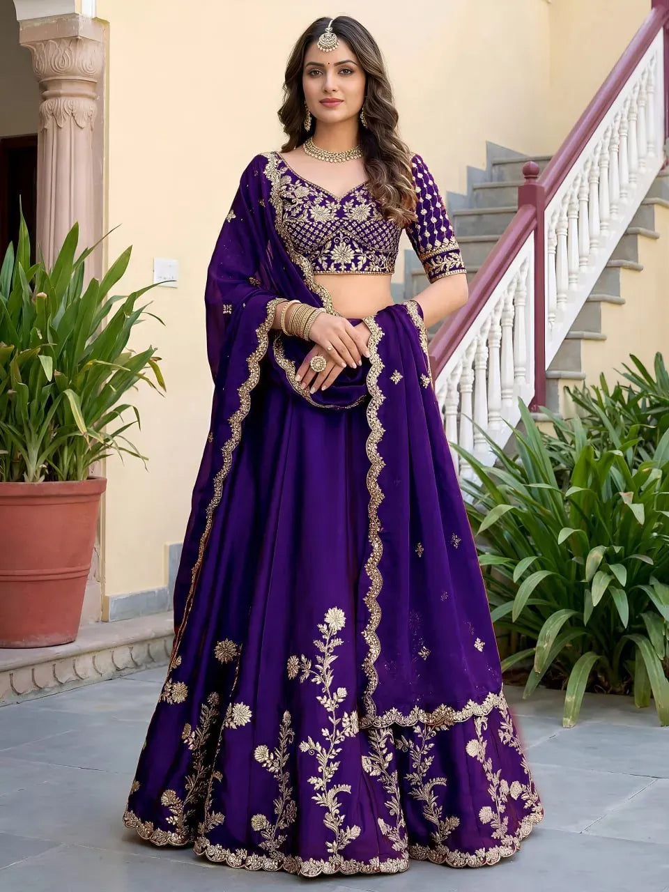 Model wearing royal purple silk lehenga with gold embroidery front view