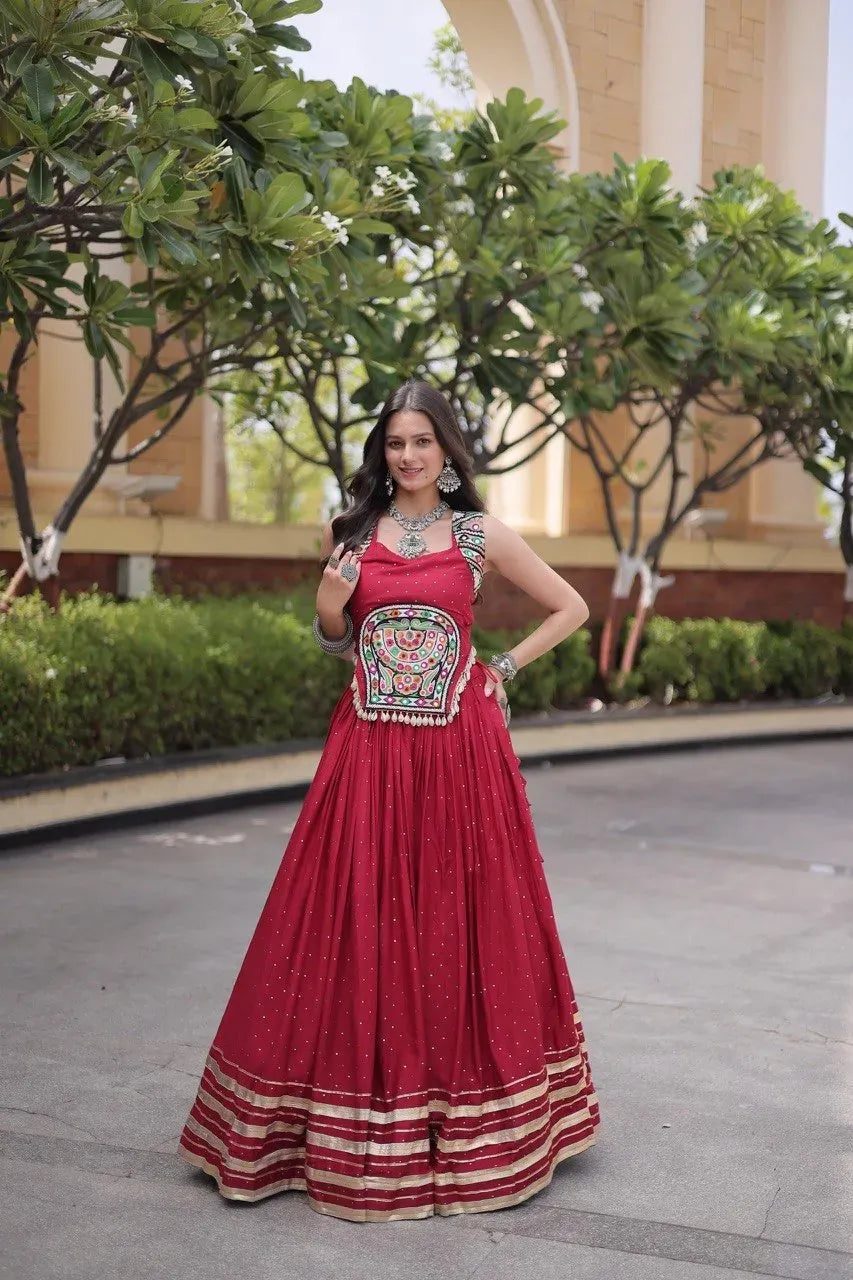 Full body view of model in deep red rayon lehenga outdoors