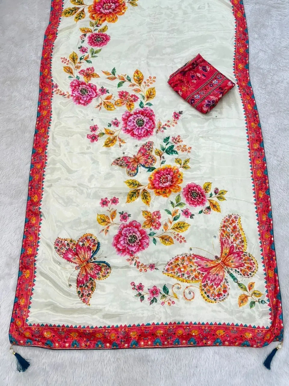 Full unrolled off-white saree with vibrant pink floral and butterfly print