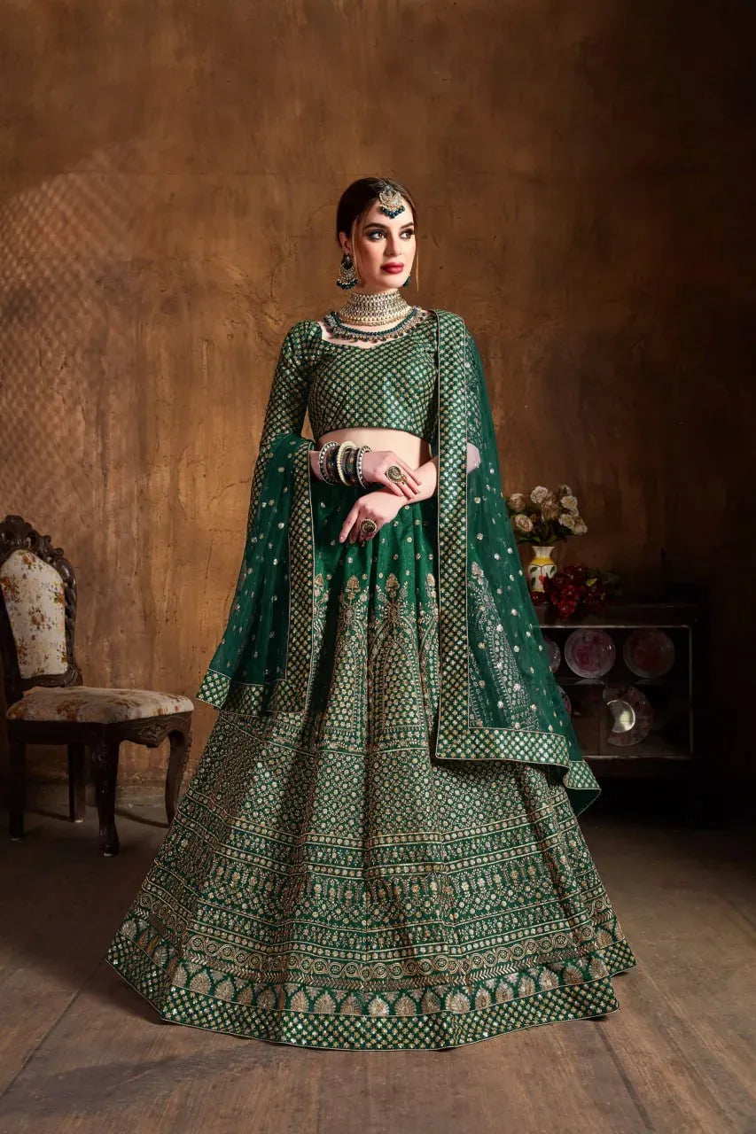 Emerald green royal embroidered lehenga choli on model with heavy gold jewelry