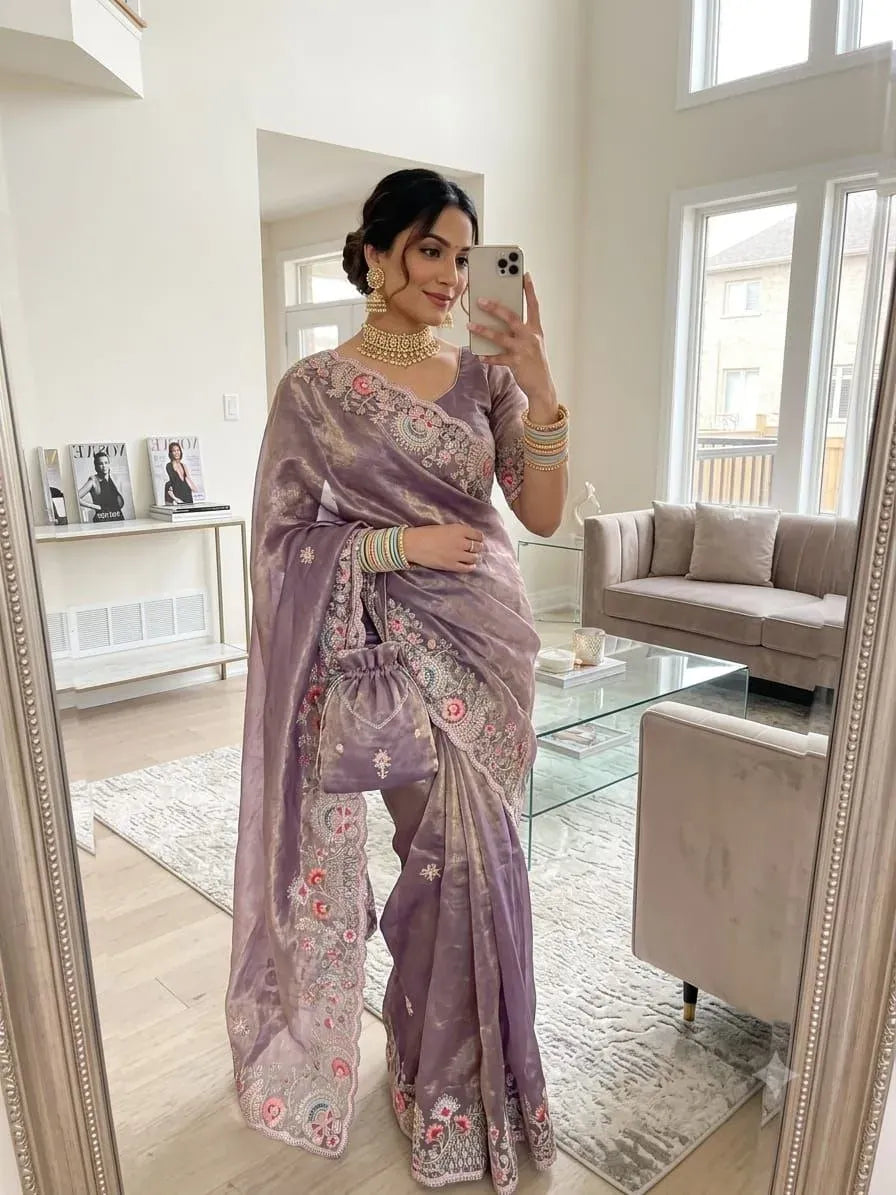 Model wearing lavender satin saree with embroidery in mirror selfie