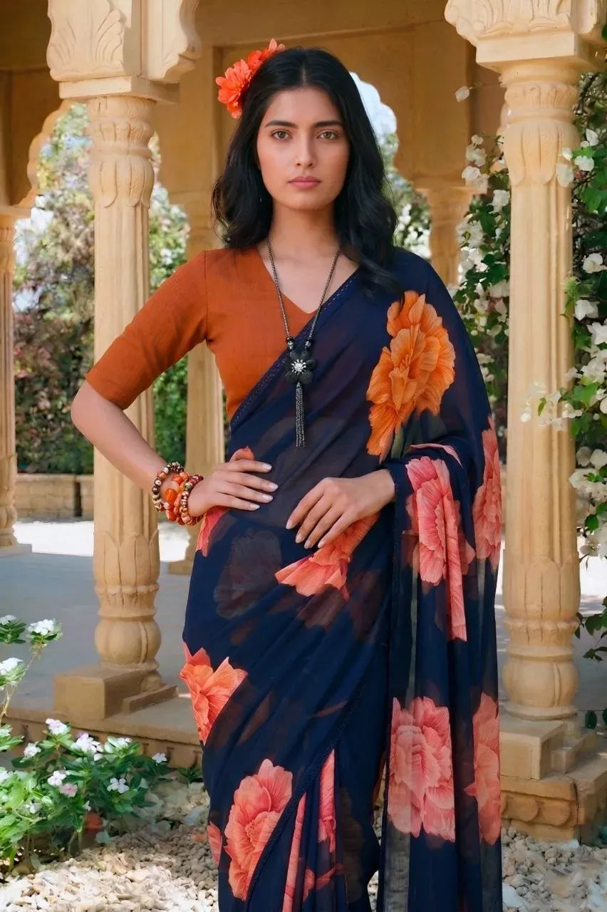 Model wearing navy blue floral chiffon saree with orange blouse