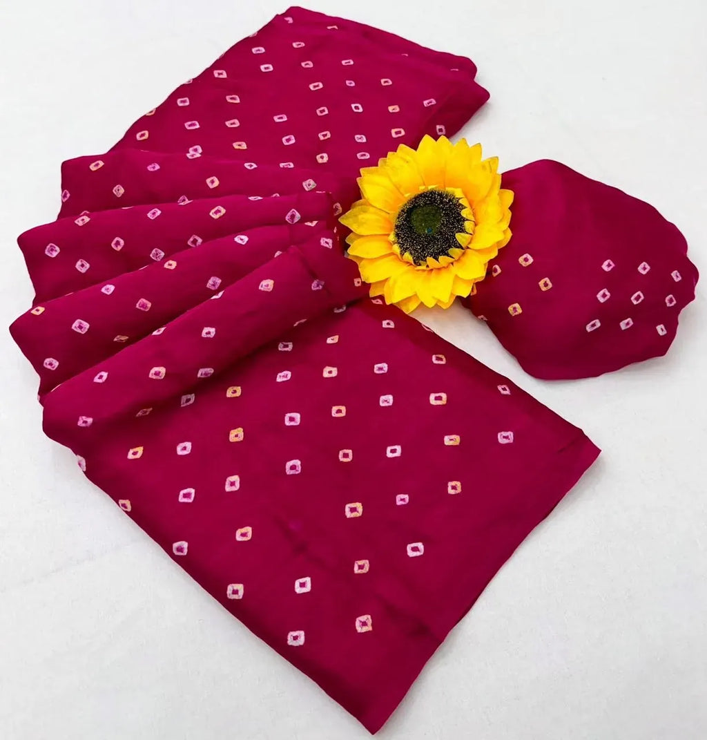 Magenta red gajisilk bandhani saree folded display with sunflower accent