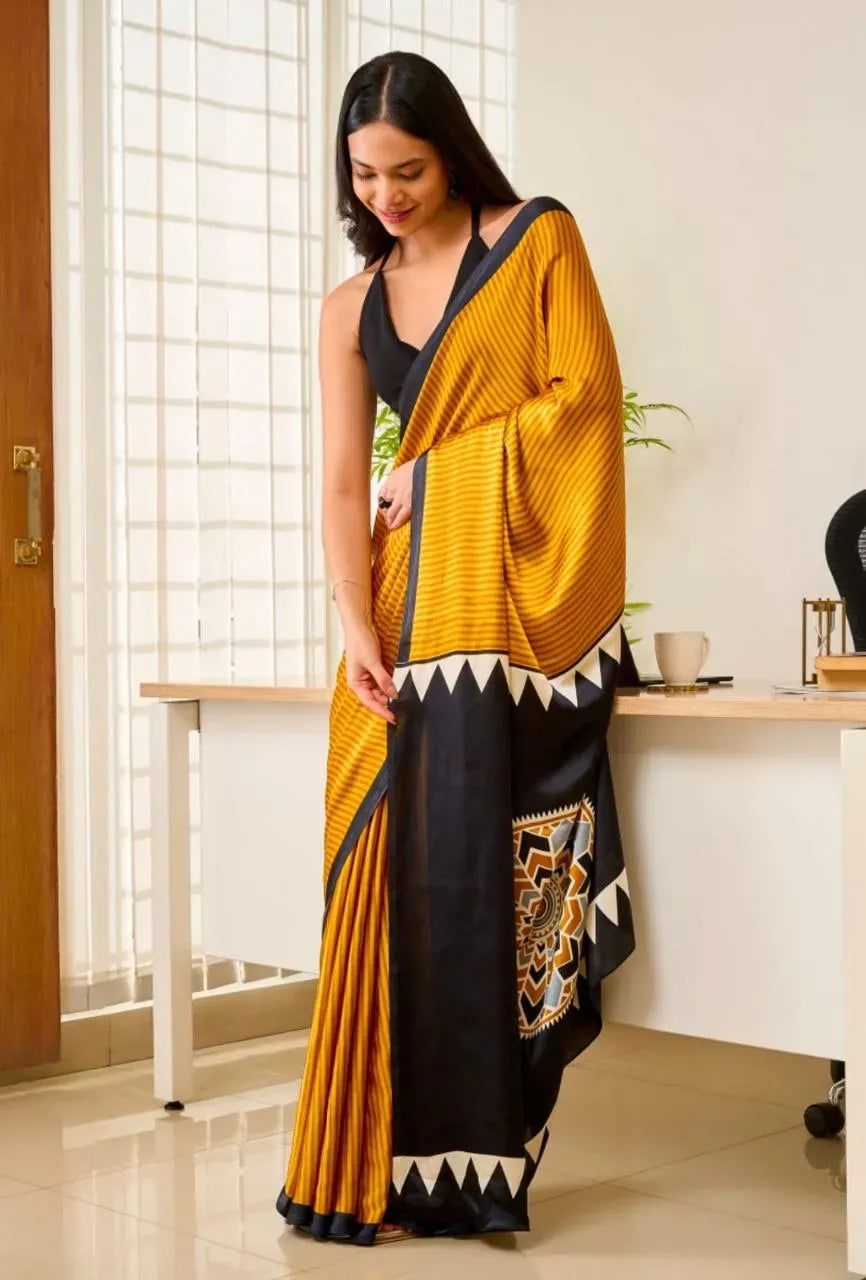 Model wearing mustard yellow gajji silk saree with black ajrakh print border