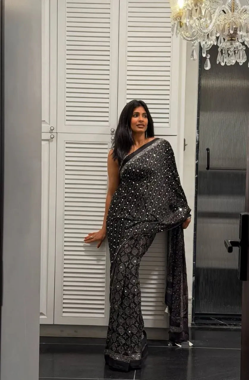 Full length front view of model posing in black gajji silk mirror work saree