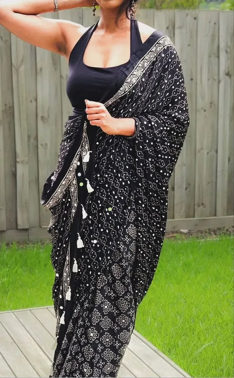 Upper body view of woman in black gajji silk saree with halter blouse