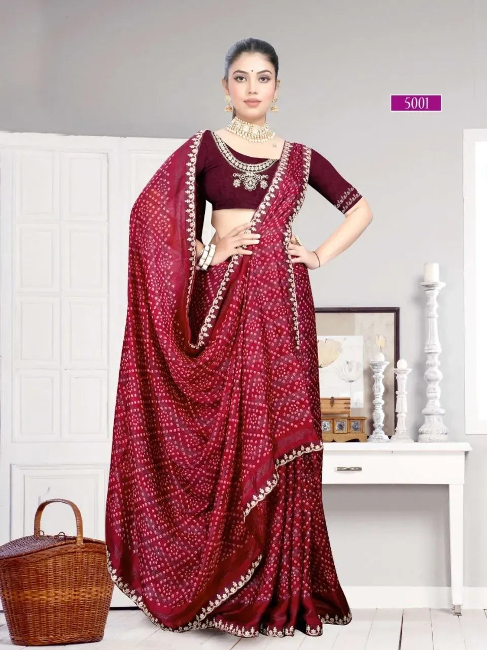 Model wearing maroon bandhani saree with heavy embroidered blouse standing front-facing