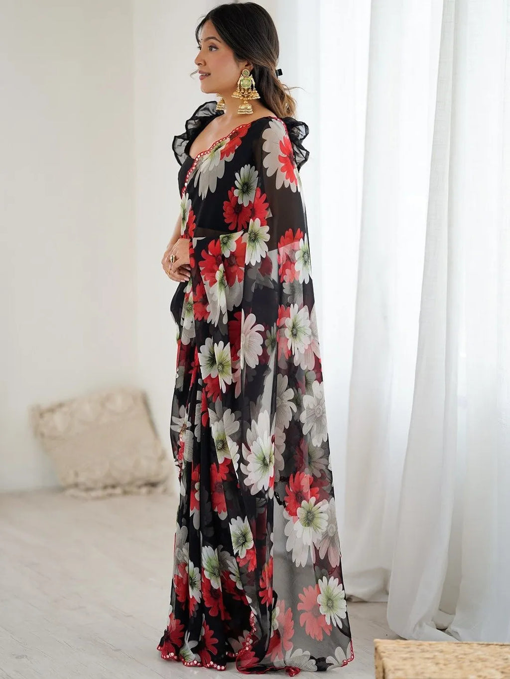 Model posing in black floral georgette silk saree front view
