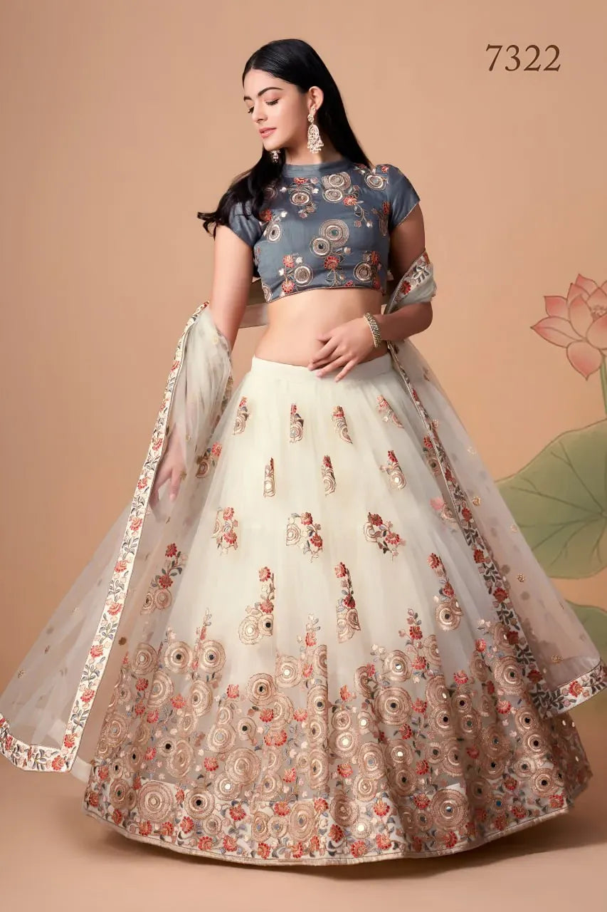 Model wearing ivory net lehenga with slate grey embroidered blouse and dupatta front view