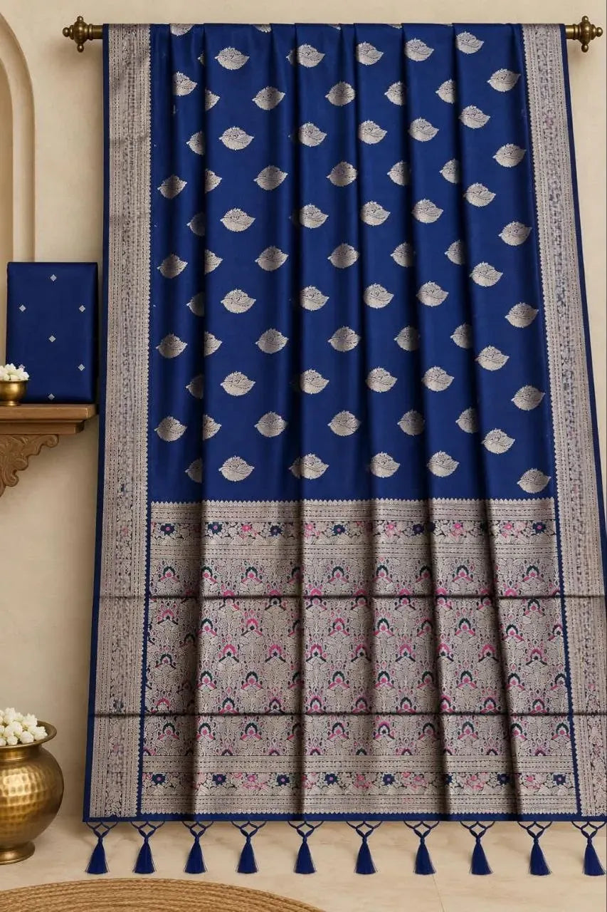 Royal blue Kanchiwaram tissue saree hanging on display with intricate silver zari border