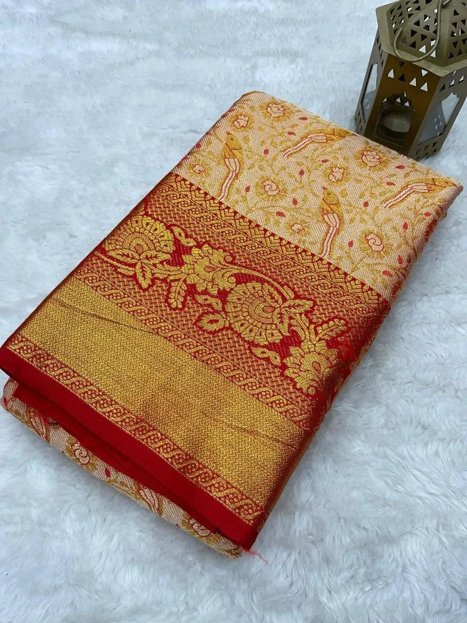 Folded pure kanjivaram silk saree with red and gold zari border