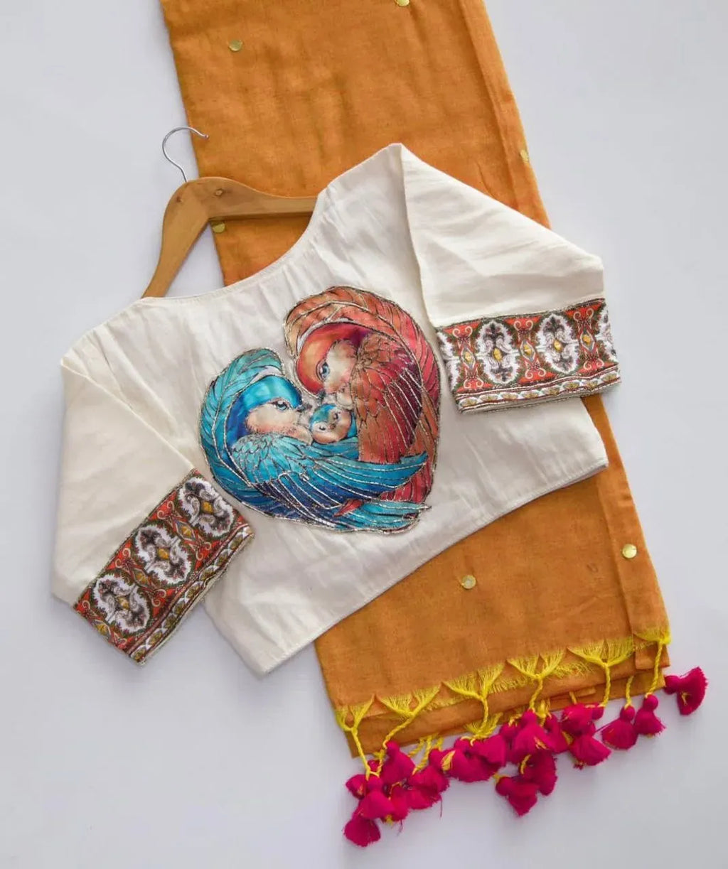 Mustard yellow khadi cotton saree paired with a white blouse featuring lovebirds artwork