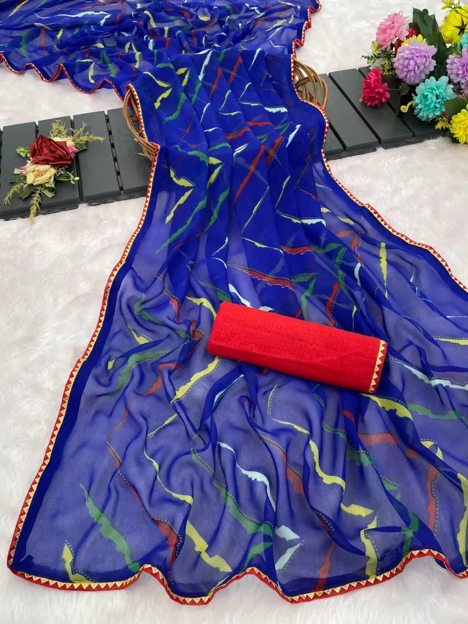 Blue lahariya print georgette saree with fancy border and red blouse piece
