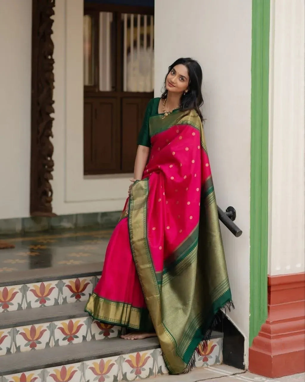 Full body standing shot of model in traditional pink and green saree