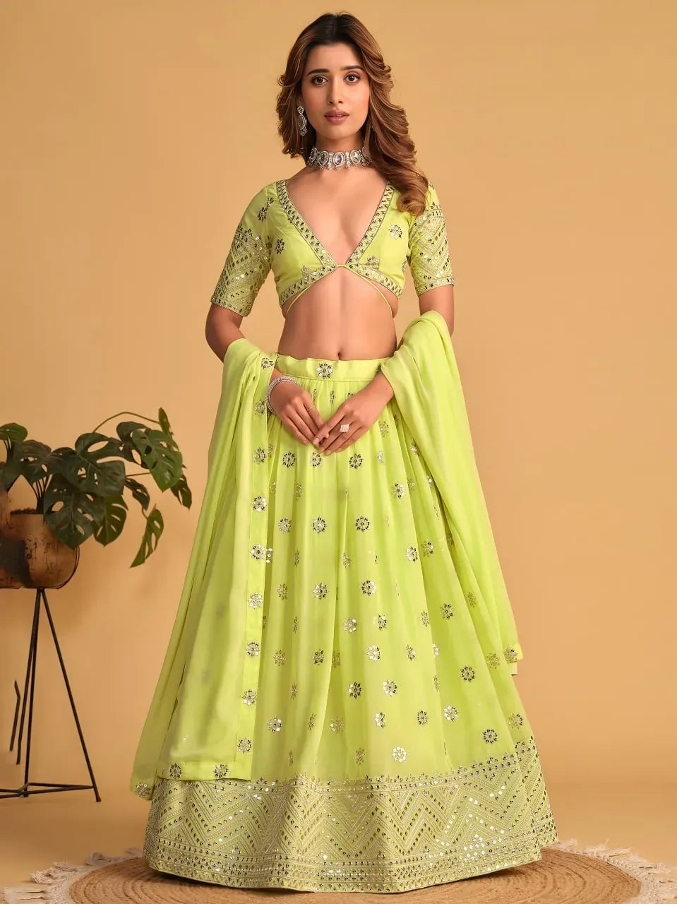 Model wearing lime green georgette lehenga with sequin embroidery front view