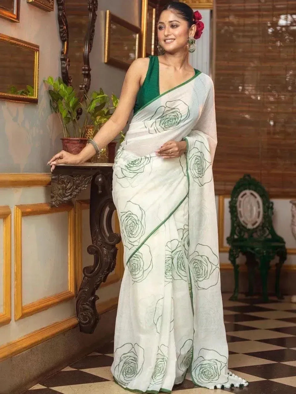 Model wearing white linen cotton saree with green floral print and green blouse
