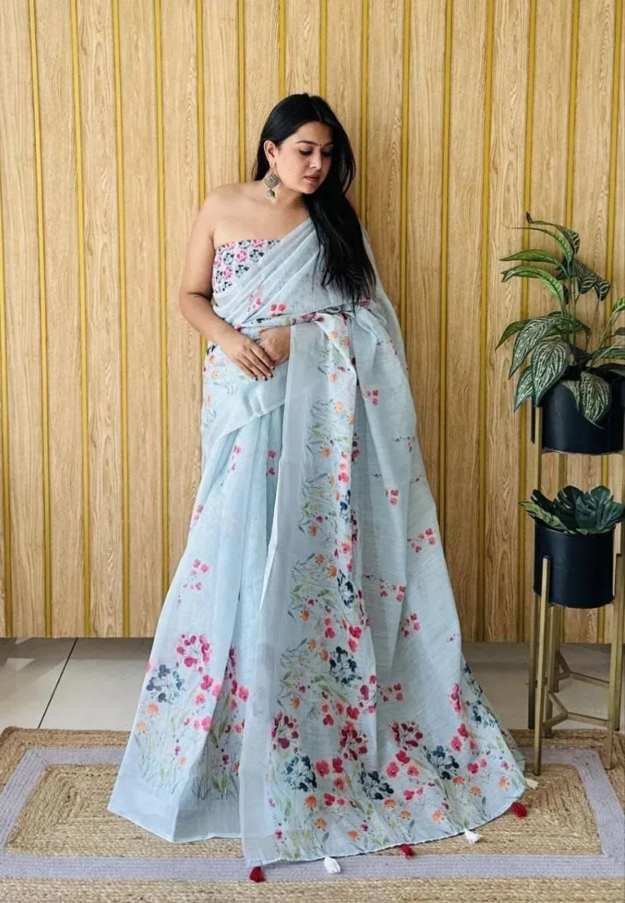 Light blue linen saree with floral digital print and silver zari border on model